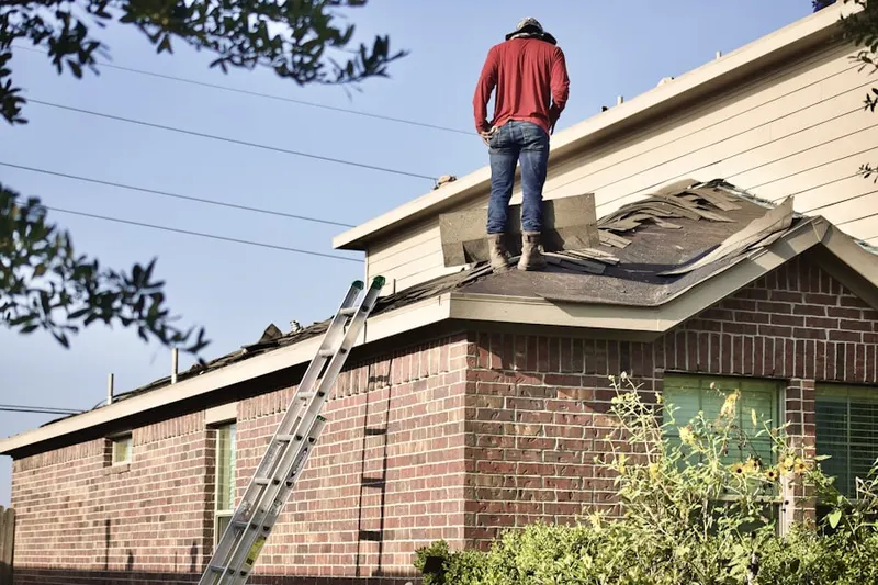 Professional roofer working on a residential roof in Spinnerville